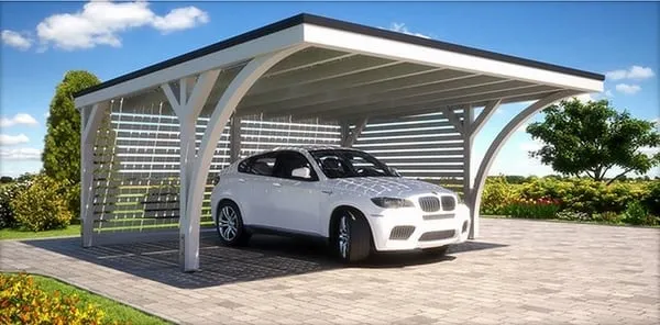 Modern and elegant carport with a white car parked underneath, set in a paved courtyard with a lush green landscape in the background.