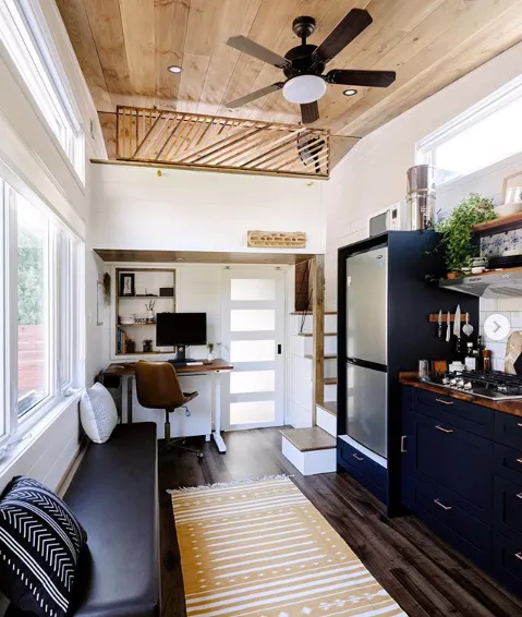 Minimalist tiny house with integrated kitchen and workspace