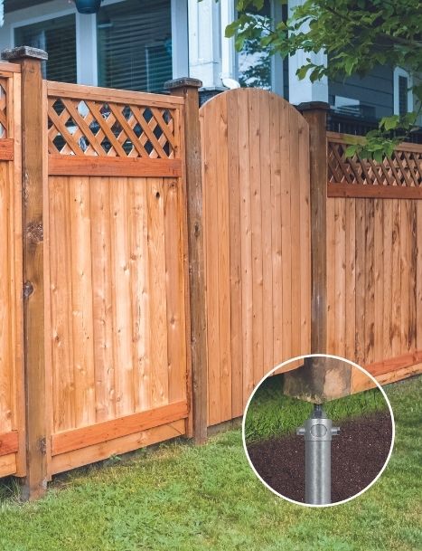 Wooden privacy fence with robust Postech Screw Piles foundation in a backyard