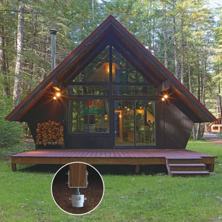 A cozy cabin nestled in the forest with a wooden deck, supported by durable screw pile foundations for stability.